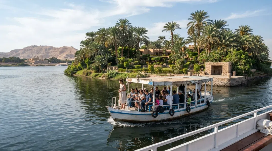 El ferry del Jolie Ville acercándose a Kings Island en el Nilo, palmeras y jardines del resort visibles en la isla privada de 60 hectáreas bajo el brillante sol de Luxor